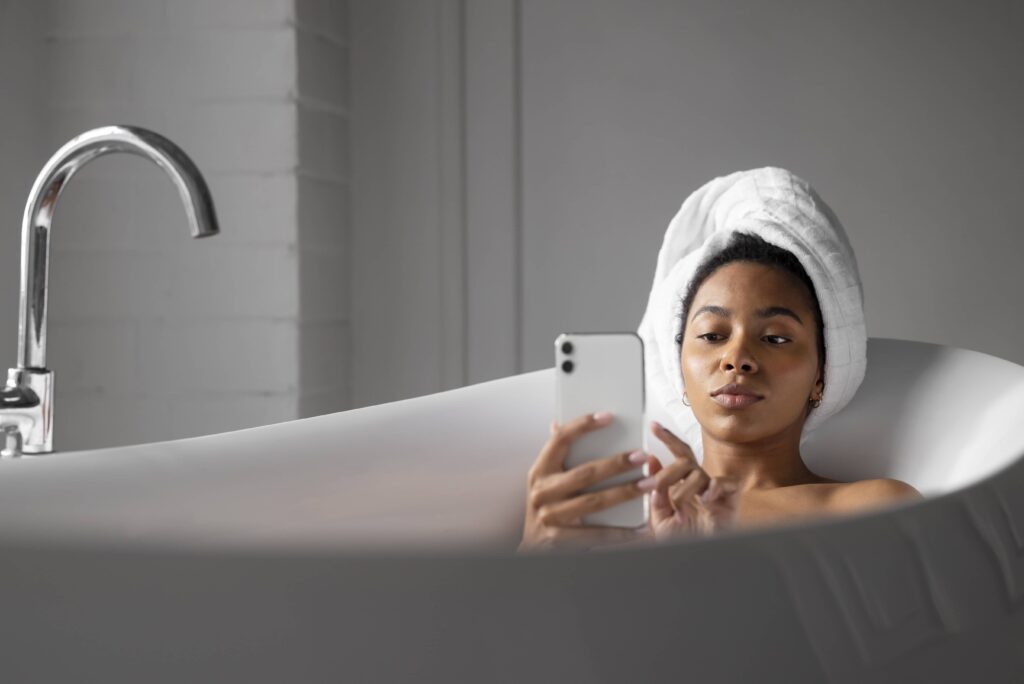 woman using dating app in the bath